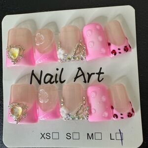 Stylish duck beak style nails in pink and clear with decorative accents.